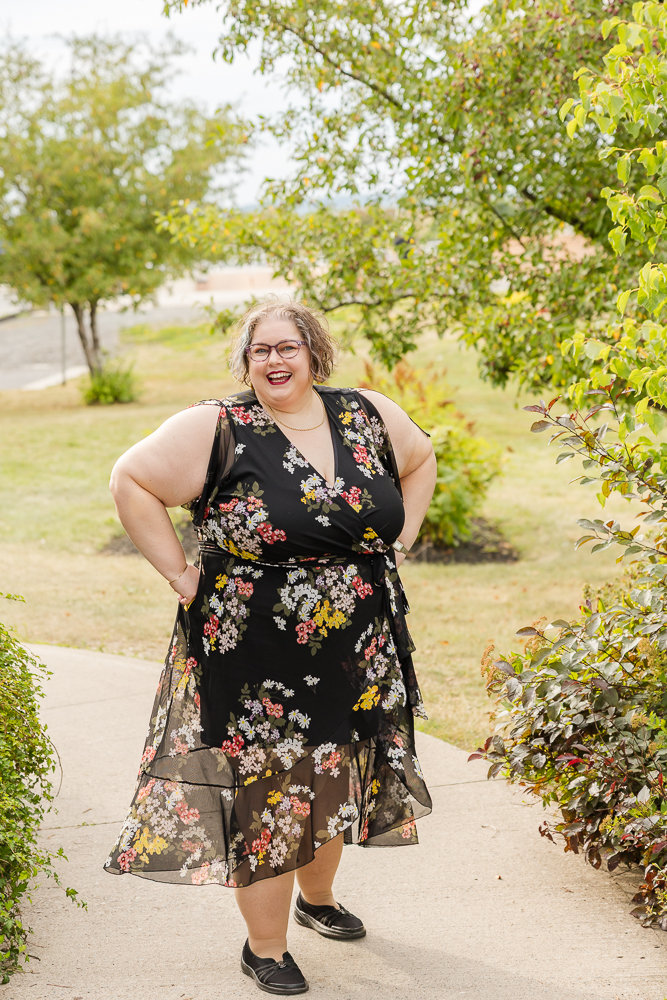 Tish MacWebber — Tishspiration Tish MacWebber smiling in a black floral dress outdoors