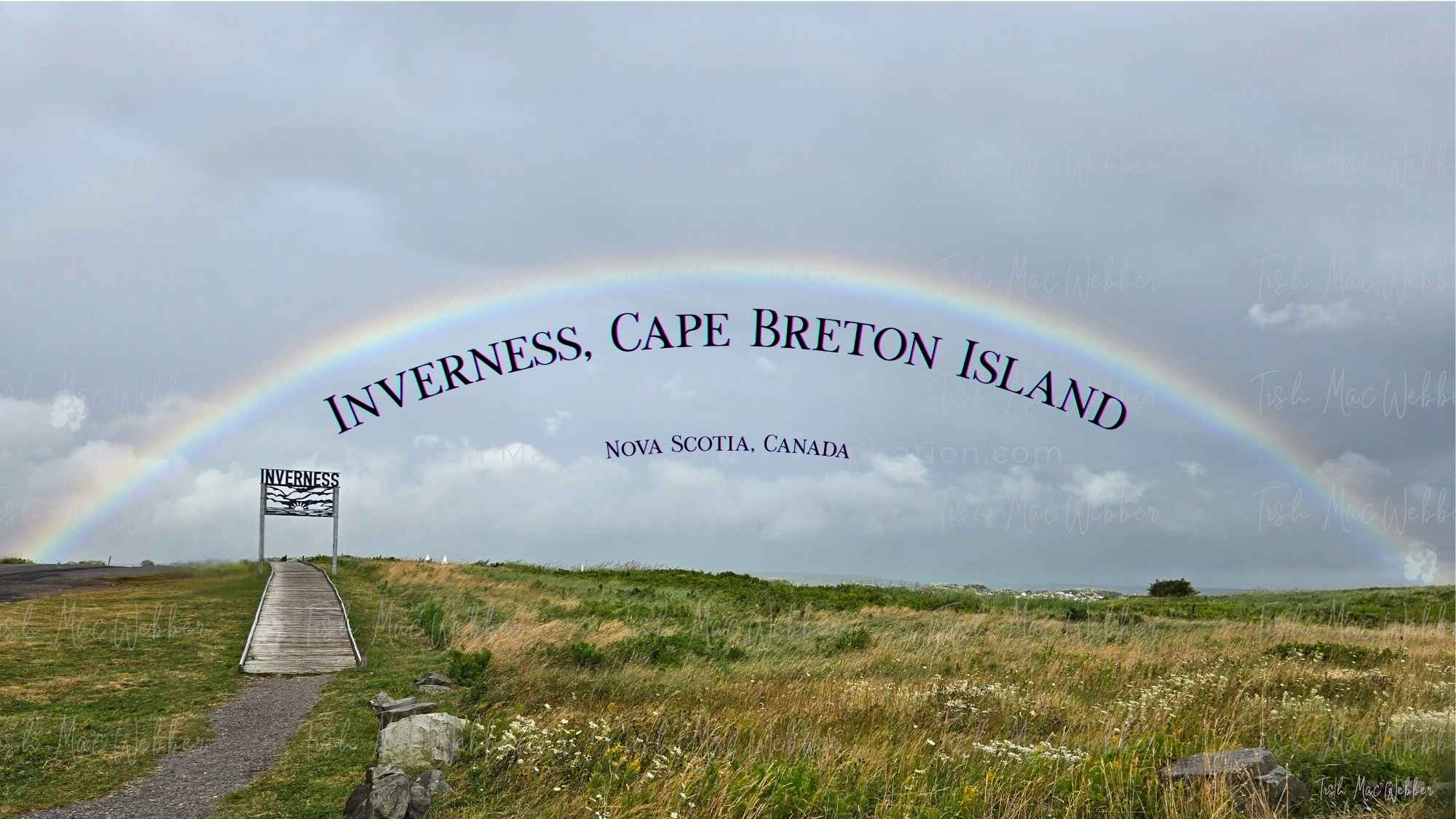 Full rainbow over the Inverness boardwalk and town with the Inverness sign and the words Inverness, Cape Breton Island, Nova Scotia, Canada