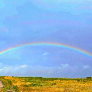 Vivid full rainbow over the Inverness boardwalk and town in Cape Breton, Nova Scotia